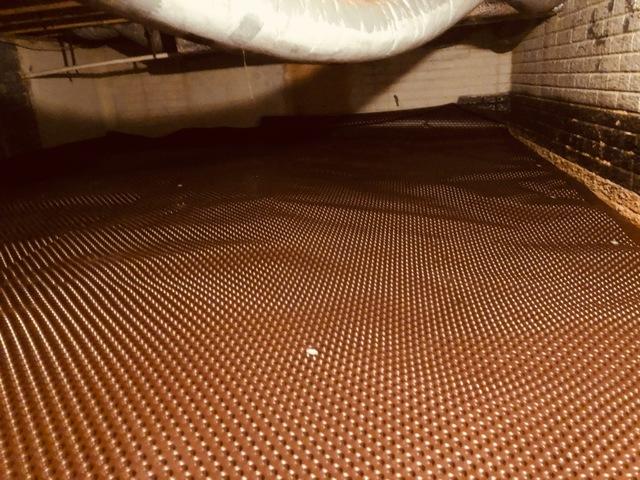 After the old, dirty insulation is removed and properly disposed of, the first step is to install our drainage matting. This matting allows water to move through the channels towards a drainage pipe and sump pump.