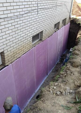 While the walls were exposed, the foundation was also waterproofed from the exterior for double the protection.