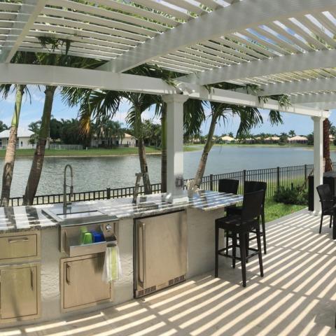 Outdoor Bar and Kitchen under an attached pergola with fixed roofing tiles