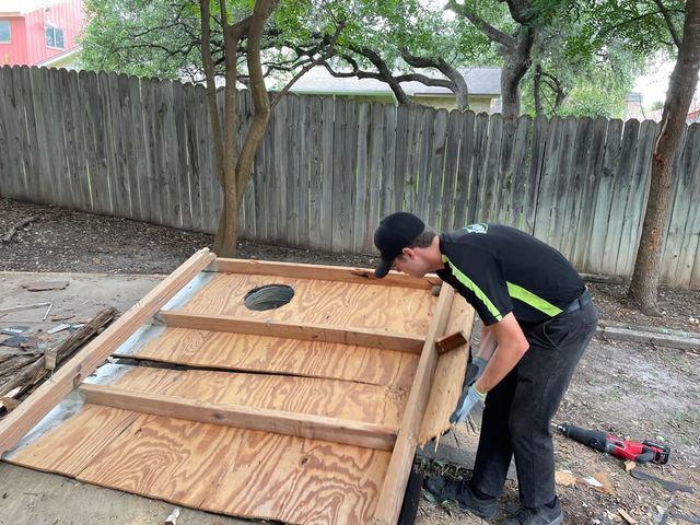 The crew getting ready to move this piece of the shed to the truck