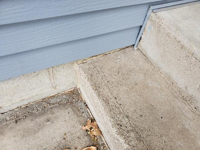 The corner of the homeowner's concrete steps before the installation.