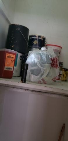 Cans of paint in closet of master bedroom.