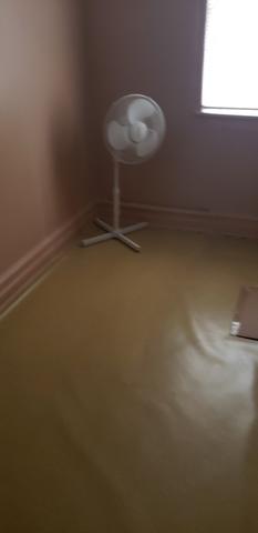 Electric Fan in the corner of the bedroom.
