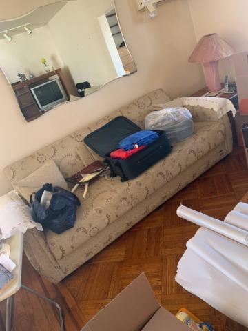 Couch in living room ready for removal.