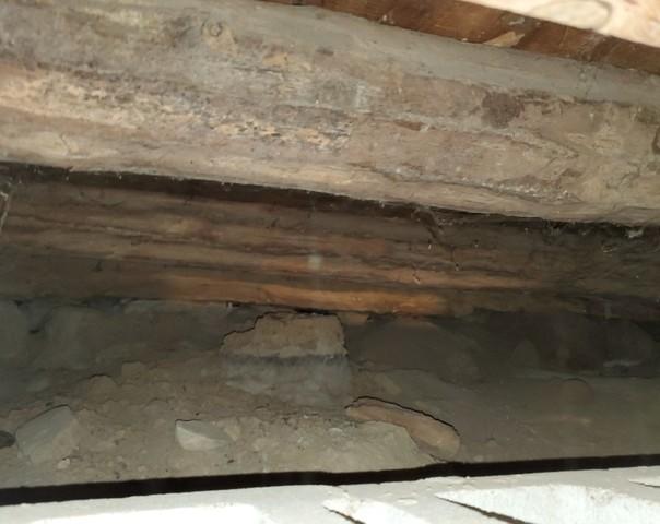 Sinking Log Beams Beneath Home