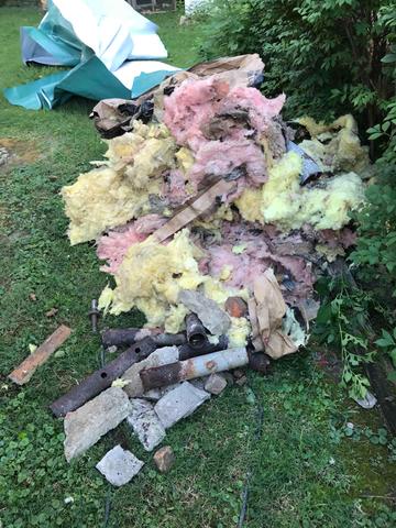 Rotten insulation and debris removed from the crawl space to allow installation of vapor barrier