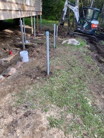 Helical Piers are Hydraulically Driven Into Ground