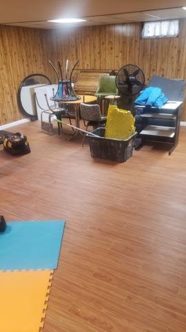 The homeowner wanted to keep her original wood panel walls, but had us install our Thermal Dry Elite Plank Flooring for her. It actually compliments the wood panels nicely and makes the room look like a cozy spa area. The homeowner had too many items to easily store elsewhere during this project so they worked with our Installation Team to find out times and areas in the finished basement that they could put their items back into when we were finished with the work in those areas.