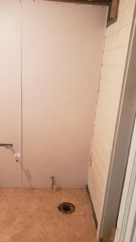 You can see the original wall, the Thermal Dry Elite Tile Flooring, and our EverLast Wall Panels in this photo. They all work very well together. And the drain and hook up for the washer and dryer are visible too. This will be a pretty and functional laundry area.