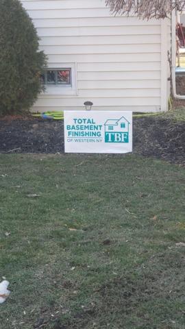 Total Basement Finishing Sign Outside The House