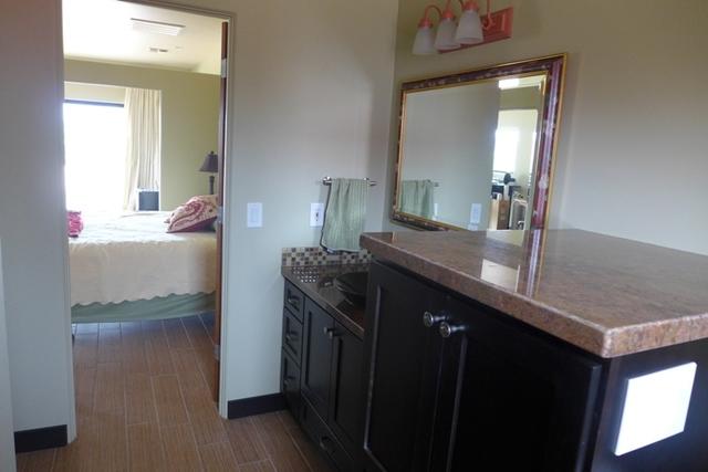 The bathroom in the casita had a water heater right in the middle of the floor. We enclosed it in a nice Starmark cabinet and carried the granite countertop from the vanity to the top of the water heater cabinet. Not only is there more counterspace, but it was a clever way to hide an eyesore.