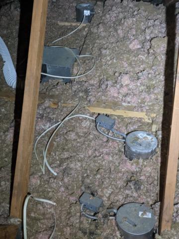 Uncovered and unsealed can lighting in the attic in Metamora, IL