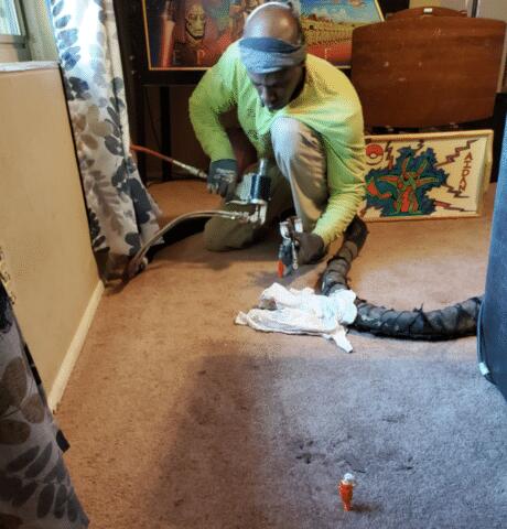 In this picture, our home hero is slowly injecting the foam material while listening to the sounds of the room to know if the floor is moving and causing a positive change in this house down in Tucson.