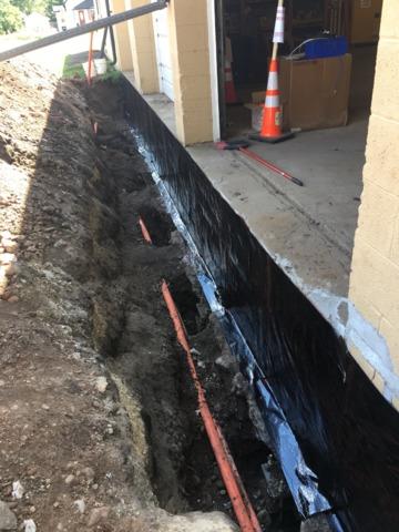 Our team began the project by digging out the surrounding soil of the facility and installing our Push Piers underneath the foundation to lift it back to its original position.