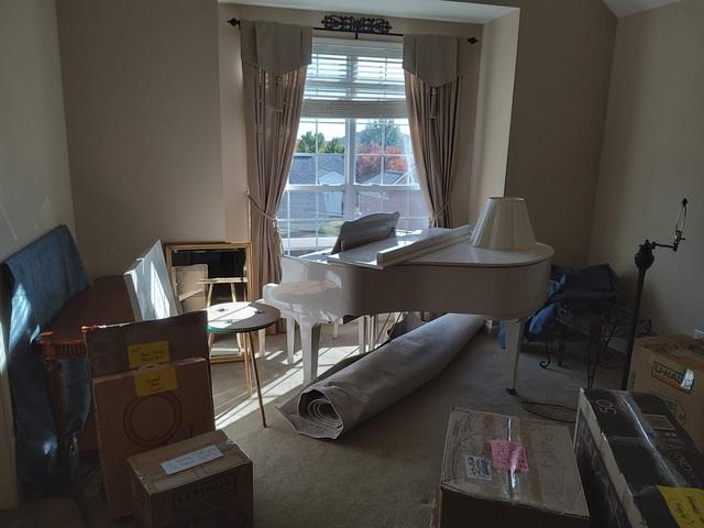 We setup the baby grand piano exactly where our customer wanted it, once we reassembled the baby grand piano from its state in the POD. Once that was done, then we were able to unload a number of other boxes, furniture, and other items into this room to empty the PODS and allow our customer to unpack and get settled in to her new home.