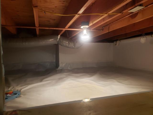 With CleanSpace vapor barrier, a drain and drainage matting installed, this crawl space is now a clean, dry and usable space.