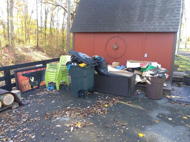 Our customer wanted this space tidied up, including removing some old patio furniture, some old artwork, household trash in the garbage cans, packaging materials, and other miscellaneous items.