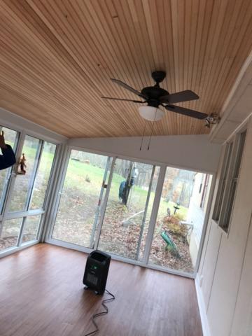 New glass enclosed porch with finished floor and ceiling.