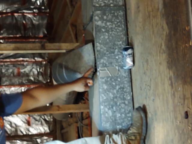 Pointing out the large gap in the ductwork in the attic above the TKE House in Bloomington IL