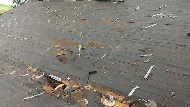Tearing off the old roof and exposing the damaged decking that will be replaced.