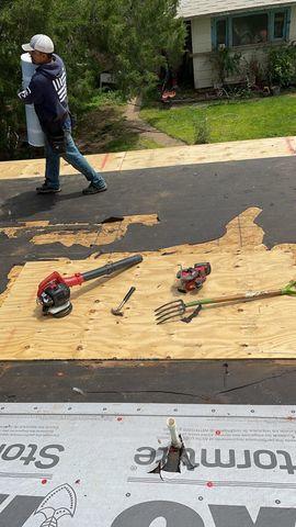 Tearing off the old roof exposes the damaged decking that is replaced.