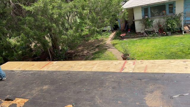 Tearing off the old roof exposes the damaged decking that is replaced.
