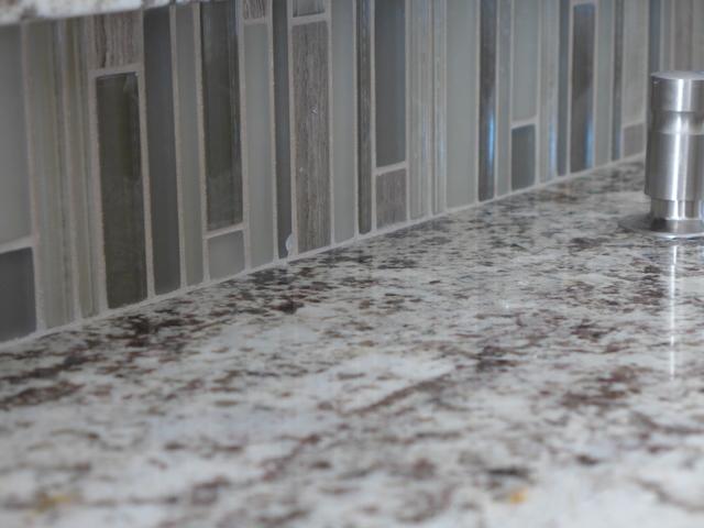 The tile backsplash theme carried throughout the house in the kitchen and two bathrooms.