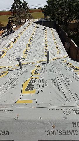 After the tear-off and decking are sound, we lay a synthetic underlayment on top of the roofing. This helps hold the integrity of the decking if damage occurs.