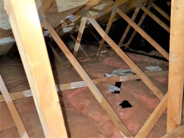 Poorly insulated attic with fiberglass