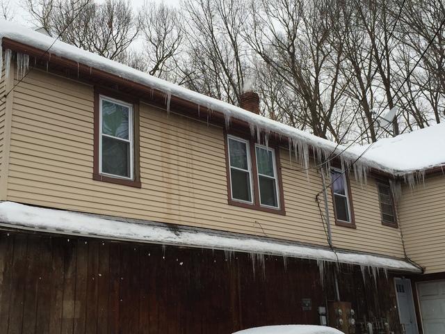 <p>When more water accumulates behind the ice dam, the water can flow over the dam to form icicles along the edge of the roof.</p>