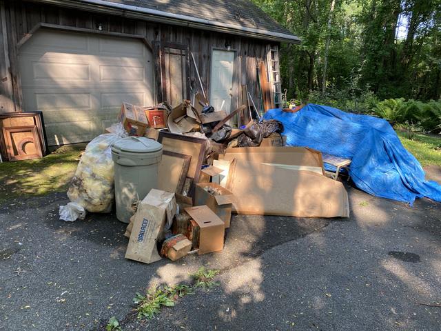 Pile of items left outside of the garage that were removed.