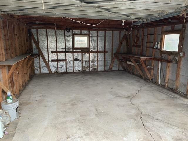 All the appliances, trash, furniture, and miscellaneous items have been removed from the garage and the space has been swept clean.