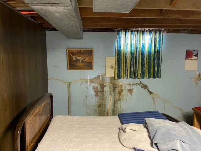 Pressure from saturated soil around the home had become too much for the block basement walls to keep out, causing them to crack, crumble and allow water to leak into the basement.