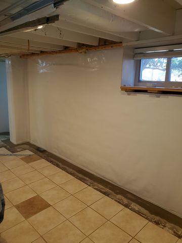 CleanSpace Vapor Barrier lines the wall to direct any wanted down into the WaterGuard system, preventing it from seeping through the finished walls that the homeowners plan on installing.