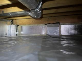 The insulation has been moved from the floor to the foundation walls. We've used R-10 SilverGlo, a Foam Board Insulation which is sealed at all seams creating an air barrier. This also moves the thermal boundary of the home from the ceiling of the crawl space to the floor of the crawl space, helping to keep floors warmer in the winter and keeping the pipes and HVAC in a less extreme environment.