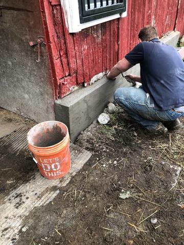 Crew member adding finishing touches to foundation repair