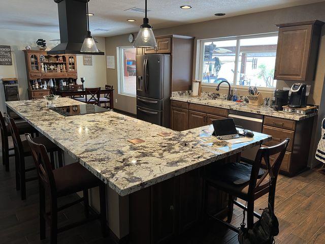 We raised the soffits of this kitchen and got rid of the fluorescent lighting for the can lighting and pendant lights.