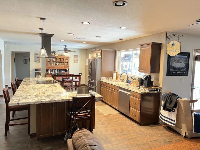 It is amazing how opening up this kitchen and updating the flooring has given this Phoenix home a warm, welcoming update.