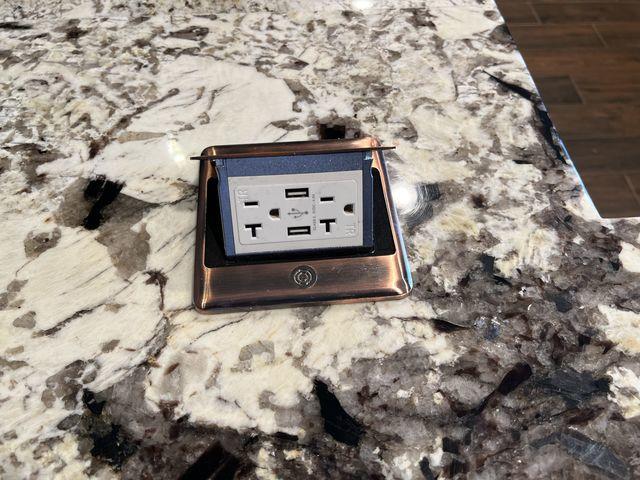Pop up power outlets with bronze plating to match the appliances.