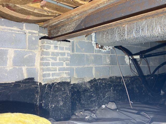 Exposed and hanging bat insulation fails to control temperatures for the rooms above.  Plastic sitting on the cold dirt floor does nothing to help improve the quality of the crawl space.