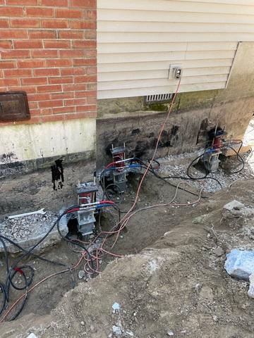 The brackets are connected to the foundation and then the Push Pier Rods are placed into the sleeve and pushed all at the same time to stabilize the home.