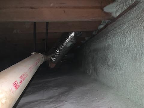 An inch and a half thick application of closed-cell spray foam was used to cover the foundation walls. This will not only insulate the crawl space but also act as an air barrier and vapor retarder, giving protection to the crawl space from outside influence. A two-inch viewing strip is left for termite inspectors.