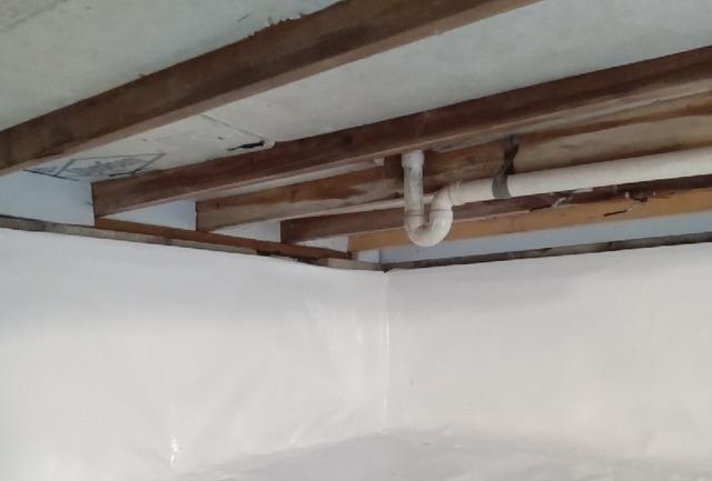 CleanSpace vapor barrier installed on the ground and walls of the crawl space to prevent moisture from passing through