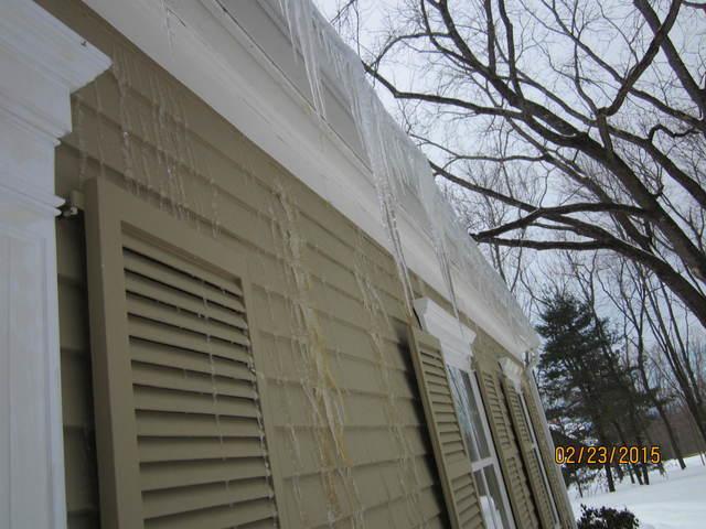 <p>Large icicles hanging off the edge of the roof is a tell-tale sign of ice damming. This Glastonbury home even has icicles forming on the siding!</p>