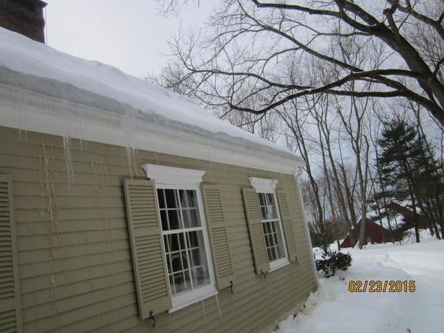 You can see the clogged gutters and icicles forming on the siding of this Glastonbury home. No wonder these homeowners had a problem! Ice dams are essentially the product of melting and re-freezing snow and are definitely a sign of energy loss through the attic