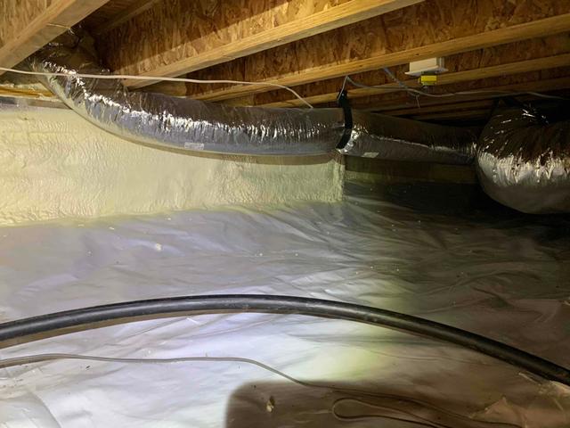 A durable 10-mil vapor barrier, called CleanSpace, was installed over the dirt flooring of the crawl space. It is wrapped around all piers, sealed with vinyl tape, and mechanically fastened to the foundation walls six to eight inches above outside grade. The CleanSpace is designed and installed to help protect the crawl space from any moisture rising from the earth and affecting the relative humidity.