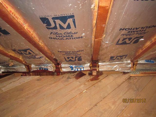 The foil-faced insulation has created a vapor barrier towards the inside.  When air gets trapped and is cooled to its dew point, it can produce water, mold and rot.