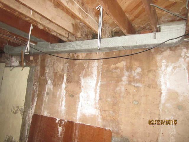 <p>The white stains on the basement wall is efflorescence, a sign of water seepage. When the soil around the foundation becomes saturated from melted snow and gutter runoff, the water can eventually find its way into the basement.</p>