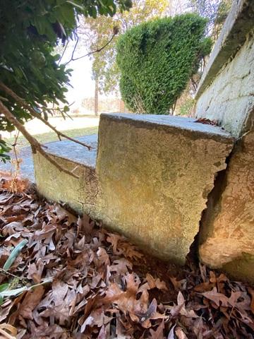 These stairs has sunken and lifted the concrete pad next to it.