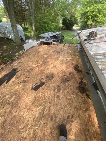 The old OSB boards are about to be removed on the roof right side